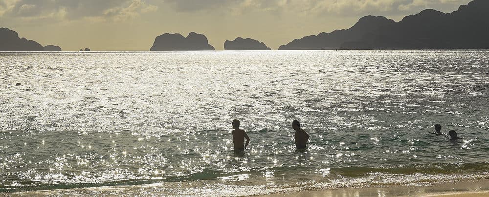 Sea sparkling as people paddle in the Philippines